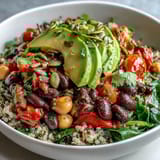 A close-up of Three-Bean Power Bowl with quinoa and zesty lemon dressing.