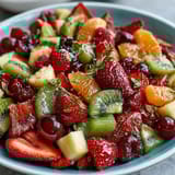 Vibrant strawberry lemonade fruit salad with juicy strawberries, blueberries, and pineapple in a zesty lemon-honey dressing.