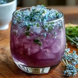 Iced Lavender Lemonade with Fresh Mint, served over ice with lemon slices and mint sprigs.