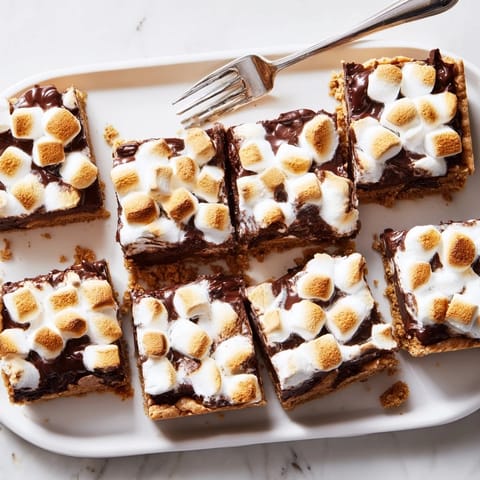 Golden-baked Smores Bars with a toasted marshmallow topping, melted chocolate, and a buttery graham cracker base.